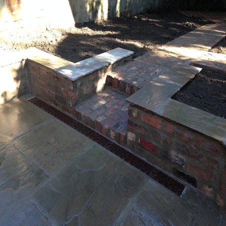 Reclaimed brick step and wall with acco drain